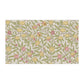 Floral patterned fabric swatch with lemons and leaves on a beige background
