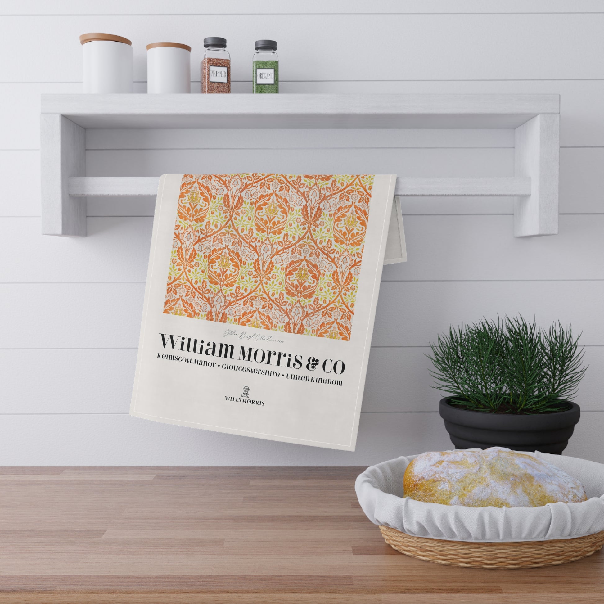 Decorative towel with William Morris & Co design hanging on a shelf in a kitchen.