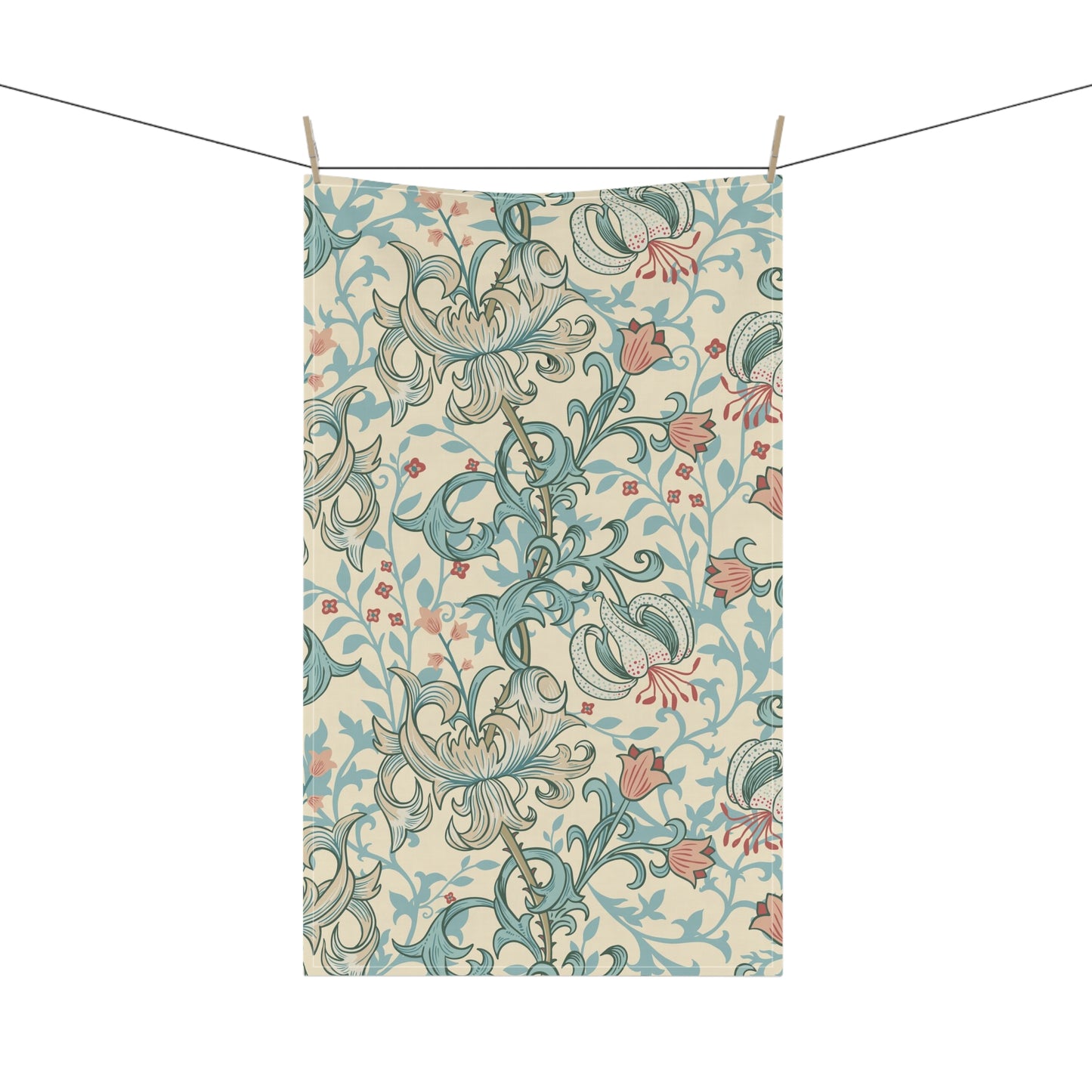 A rectangular fabric tea towel with an ornate floral pattern, suspended by clips from a string against a plain white background.