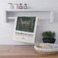 Tea towel with nature design and 'William Morris & Co' text hanging on a shelf.