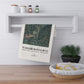 Tea towel with nature design and 'William Morris & Co' text hanging on a shelf.