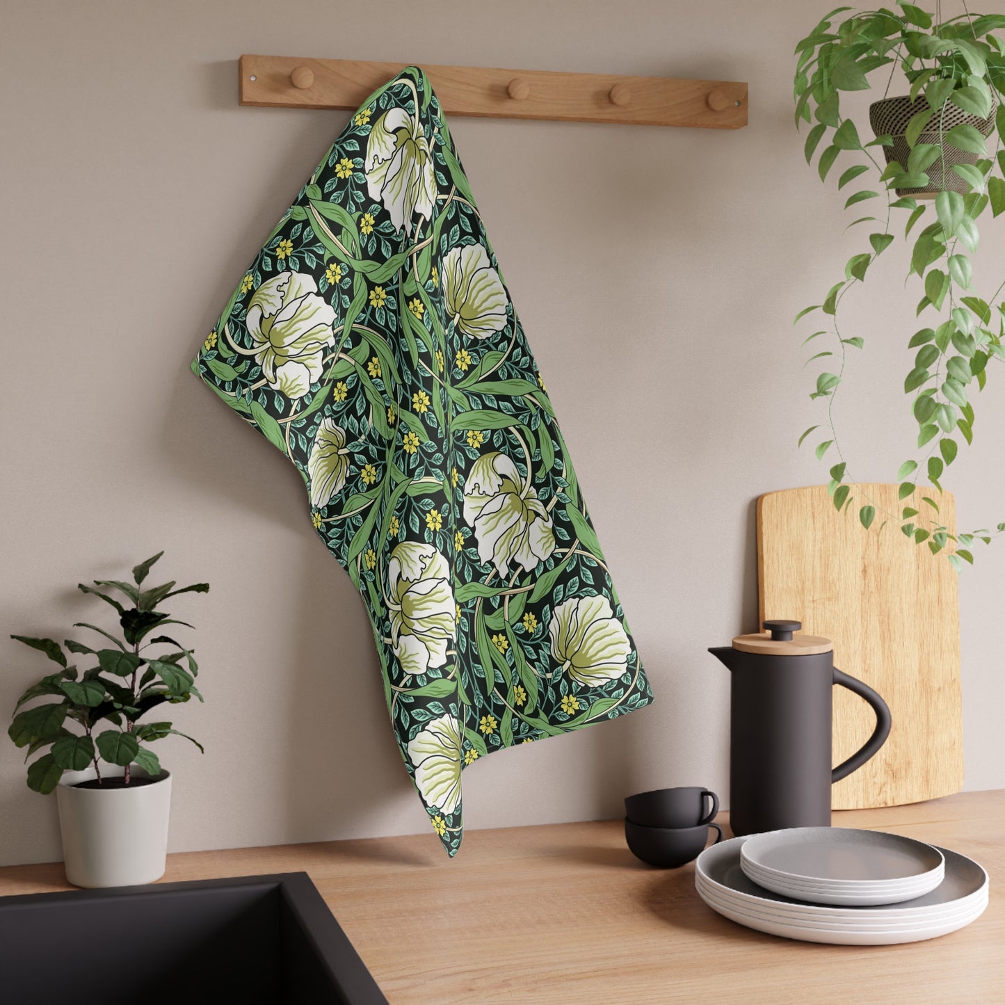 A kitchen tea towel with a green background and a floral pattern inspired by William Morris - Pimpernel Collection.