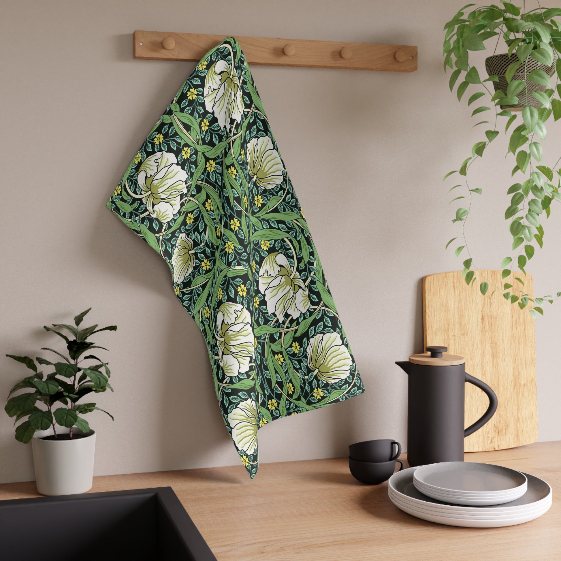 A kitchen tea towel with a green background and a floral pattern inspired by William Morris - Pimpernel Collection.