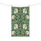 A kitchen tea towel with a green background and a floral pattern inspired by William Morris - Pimpernel Collection.