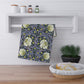 A kitchen tea towel with a floral pattern inspired by William Morris - Pimpernel Collection in lavender colour.