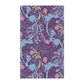 A kitchen tea towel featuring a repeating pattern of seaweed and pink flowers on a purple background.