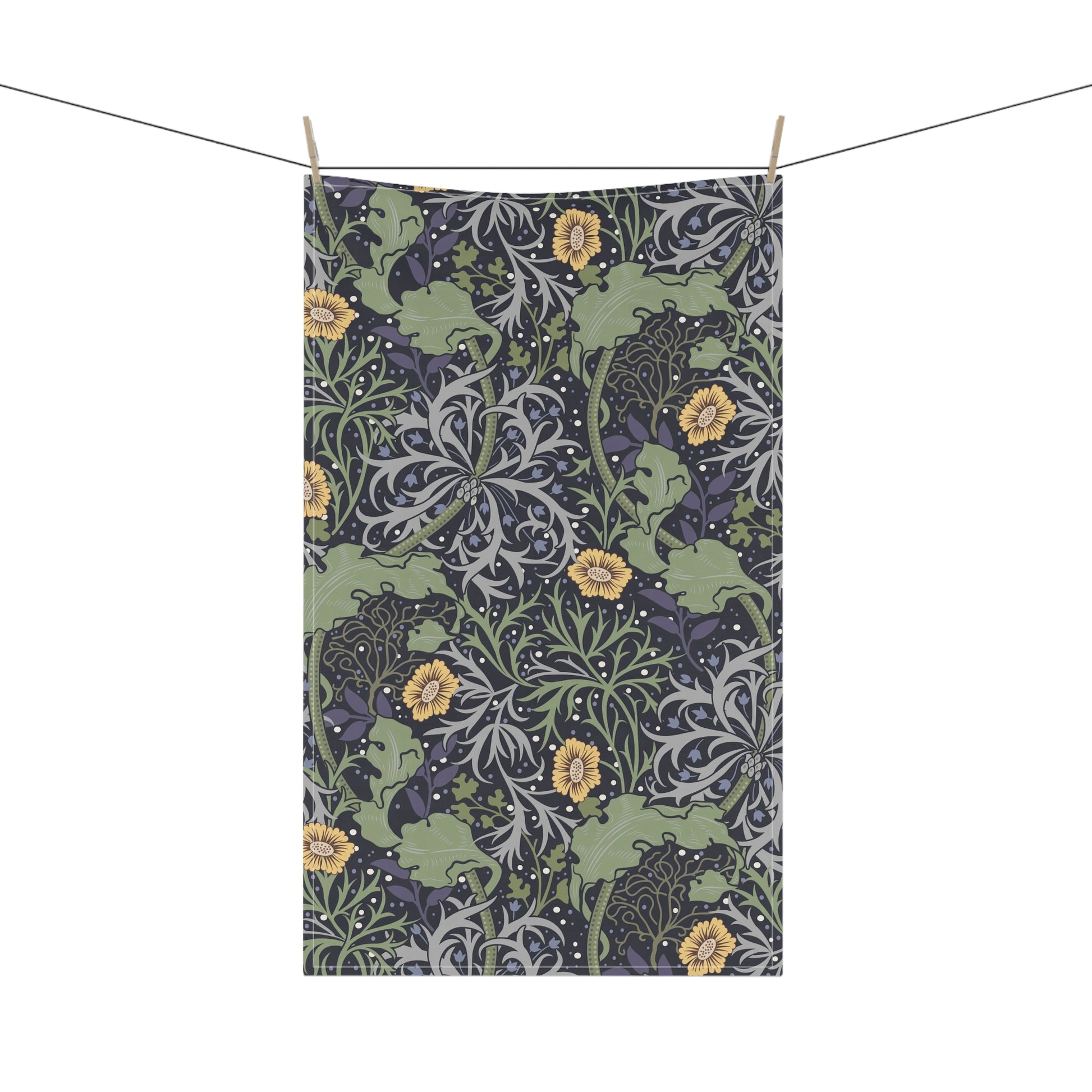 A rectangular kitchen tea towel featuring a repeating pattern of seaweed and yellow flowers on a green background.