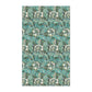 A kitchen tea towel with a floral pattern inspired by William Morris, in shades of blue, green, and white.