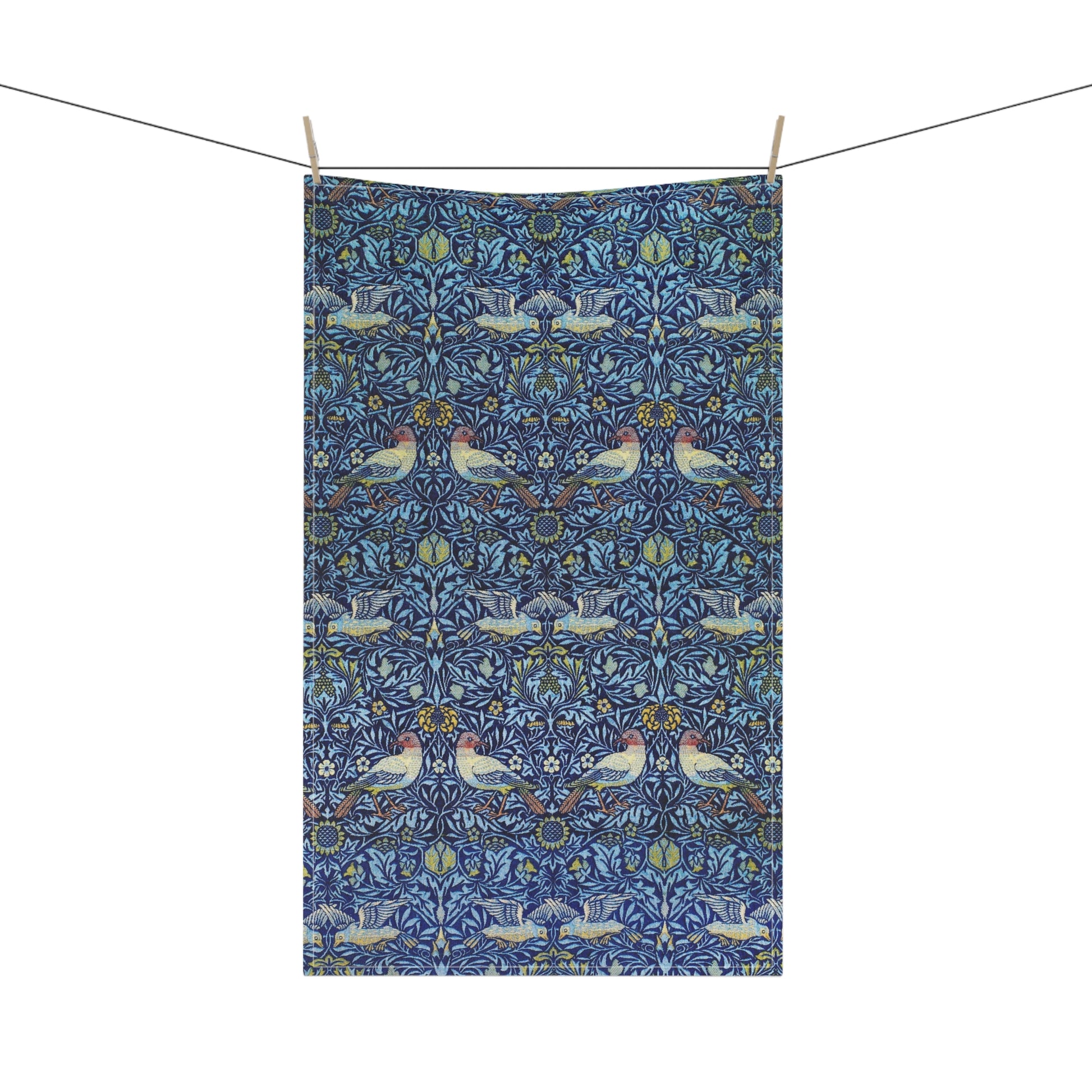 Decorative fabric with a pattern of birds and flowers hanging on a line.