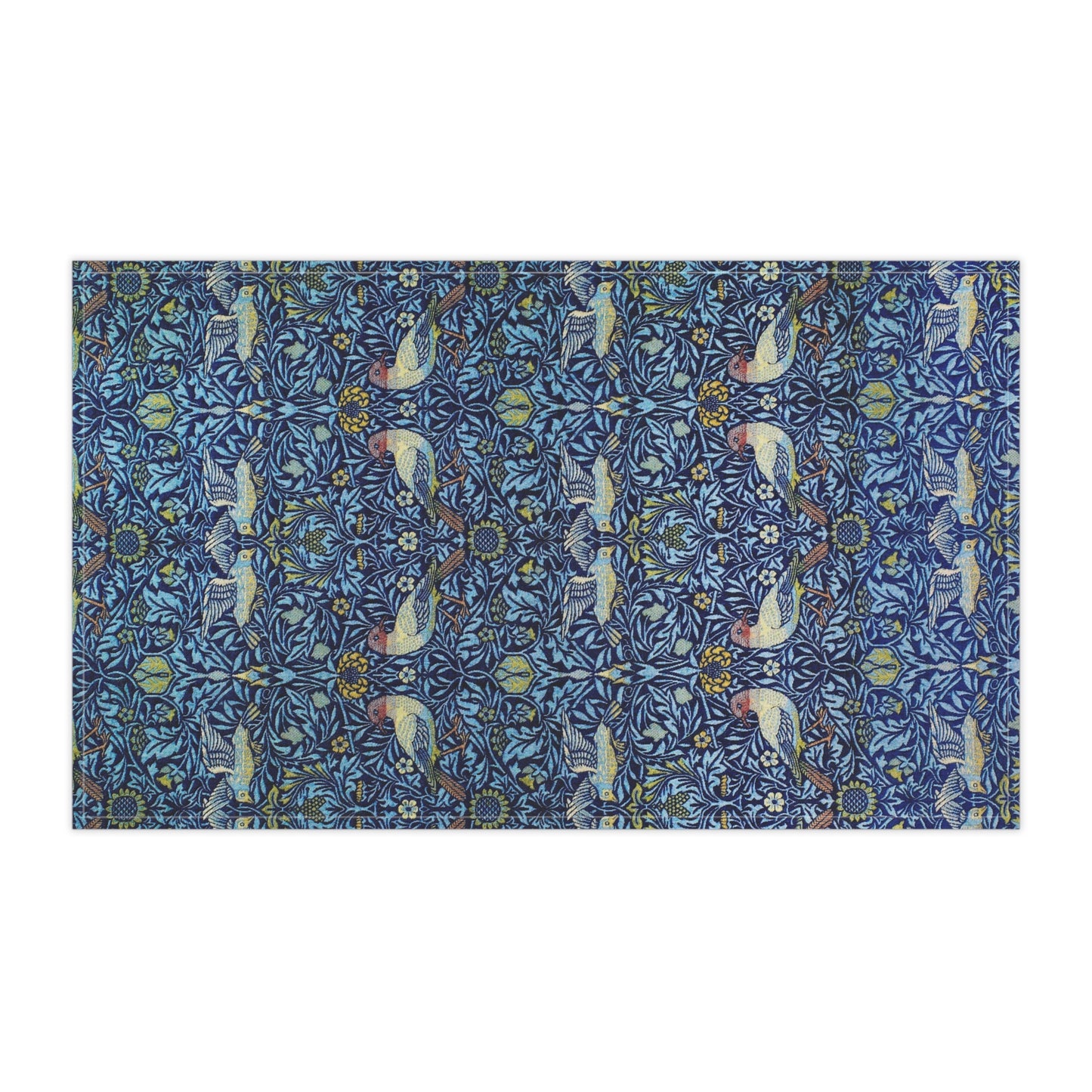 Decorative tea towel with a blue pattern featuring birds and floral elements on a white background