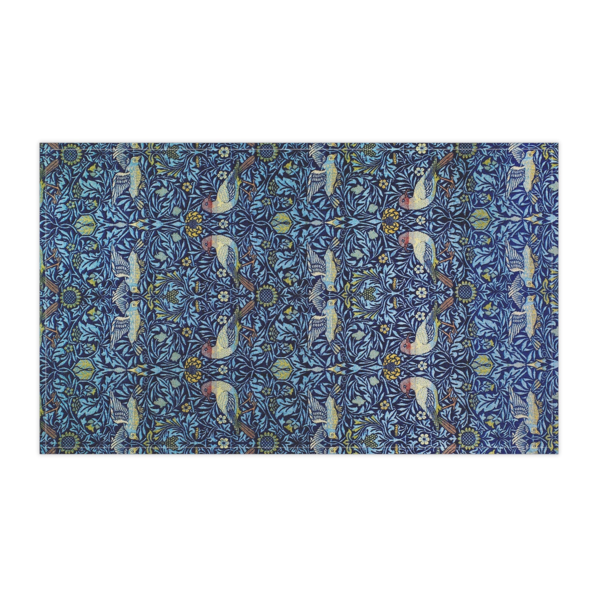 Decorative tea towel with a blue pattern featuring birds and floral elements on a white background
