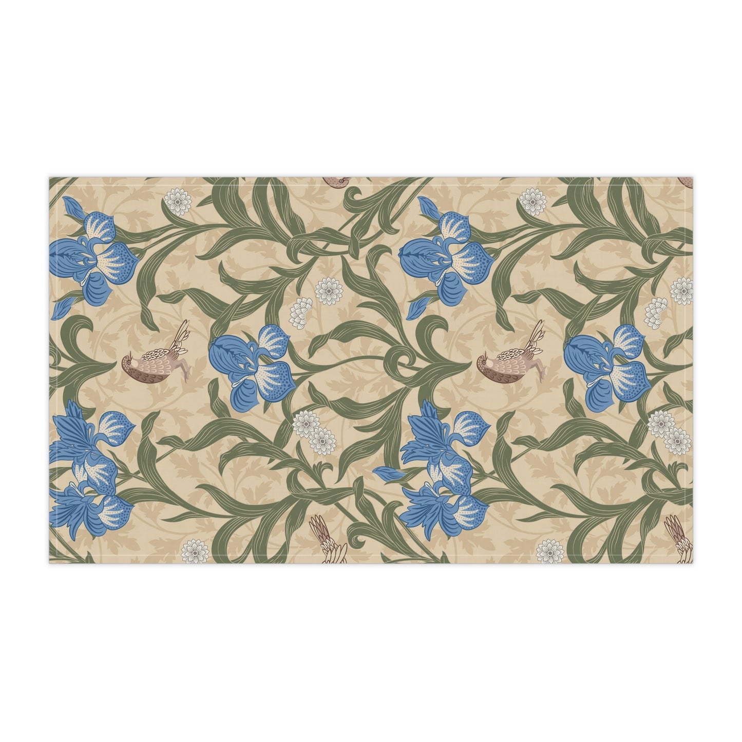 A kitchen tea towel with a William Morris & Co floral pattern featuring blue irises, birds, and a beige background.