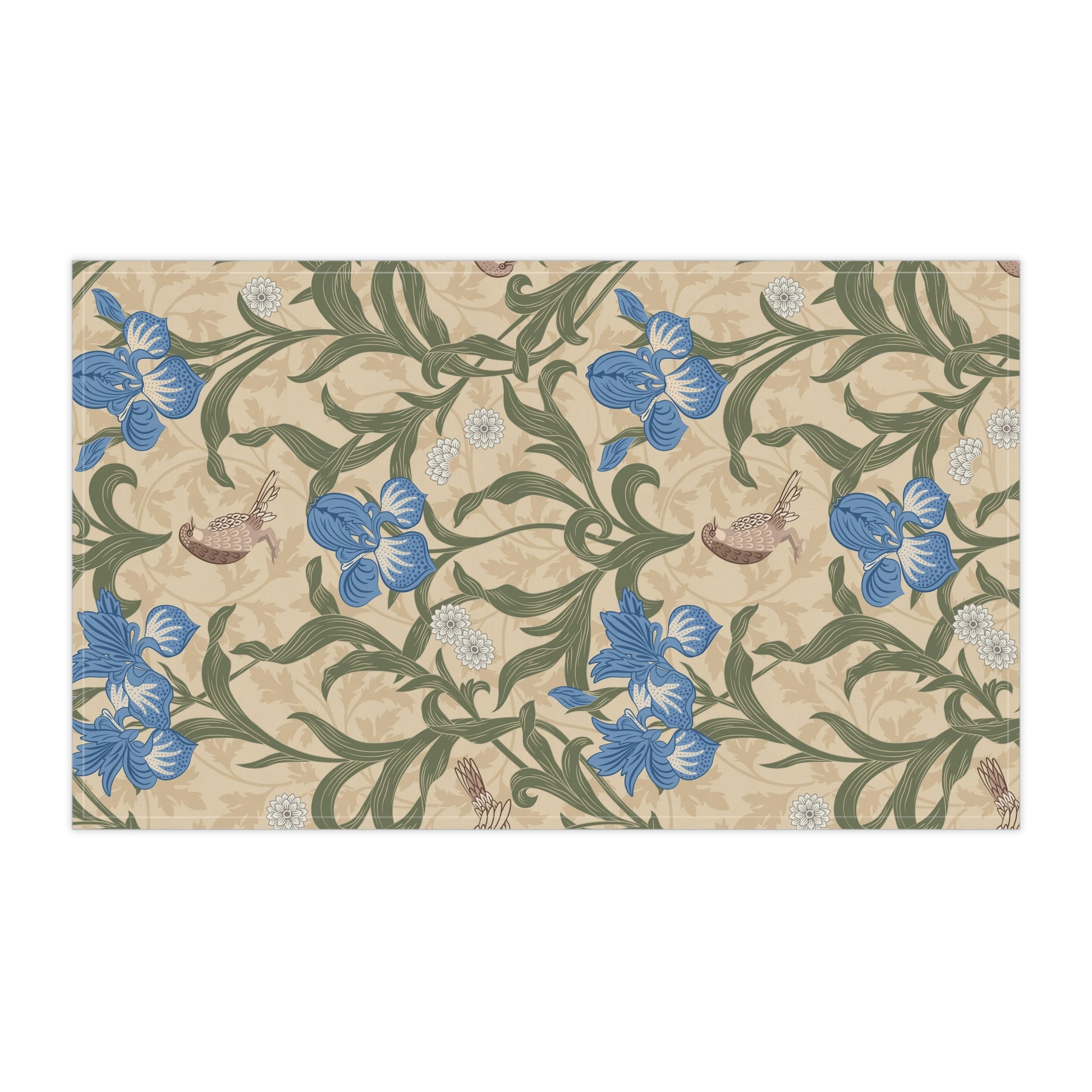A kitchen tea towel with a William Morris & Co floral pattern featuring blue irises, birds, and a beige background.