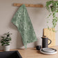 A kitchen tea towel with a green floral pattern inspired by William Morris & Co - Marigold Collection.