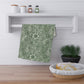 A kitchen tea towel with a green floral pattern inspired by William Morris & Co - Marigold Collection.