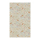 Decorative tea towel with floral and bird pattern on a white background