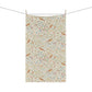 Floral and bird patterned towel hanging on a line