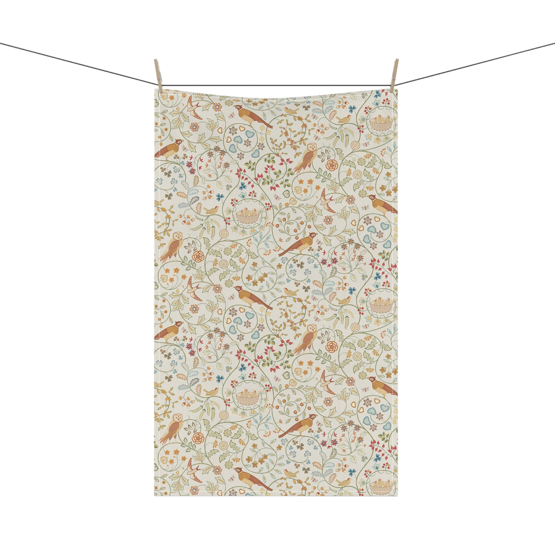 Floral and bird patterned towel hanging on a line