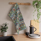 A kitchen tea towel with a floral and geometric pattern inspired by William Morris - Snakeshead Collection.