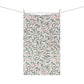 Towel with leaf pattern hanging on a line
