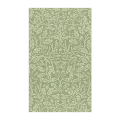 A green kitchen tea towel with a floral and leaf pattern inspired by William Morris & Co - Acorn and Oak Leaves Collection.