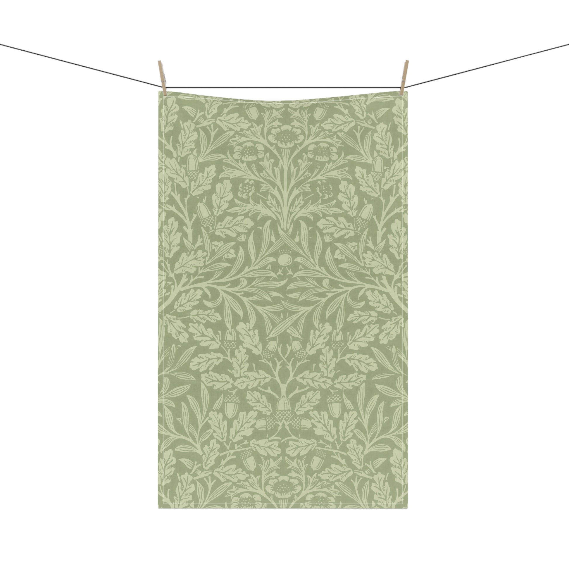 A green kitchen tea towel with a floral and leaf pattern inspired by William Morris & Co - Acorn and Oak Leaves Collection.