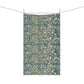 A rectangular kitchen tea towel with a floral and bird pattern in a teal colour inspired by William Morris & Co.