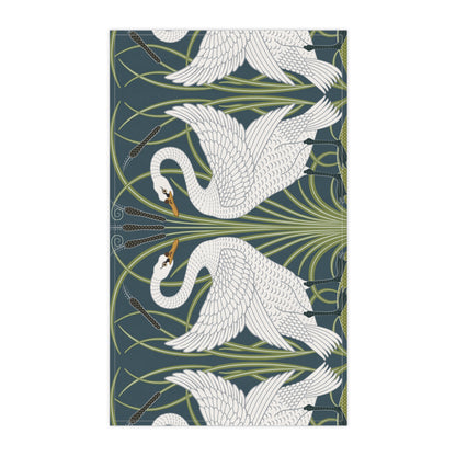 A kitchen tea towel featuring a repeated pattern of a white swan with a green and brownish background, and a set of dishes with cutlery on the side.