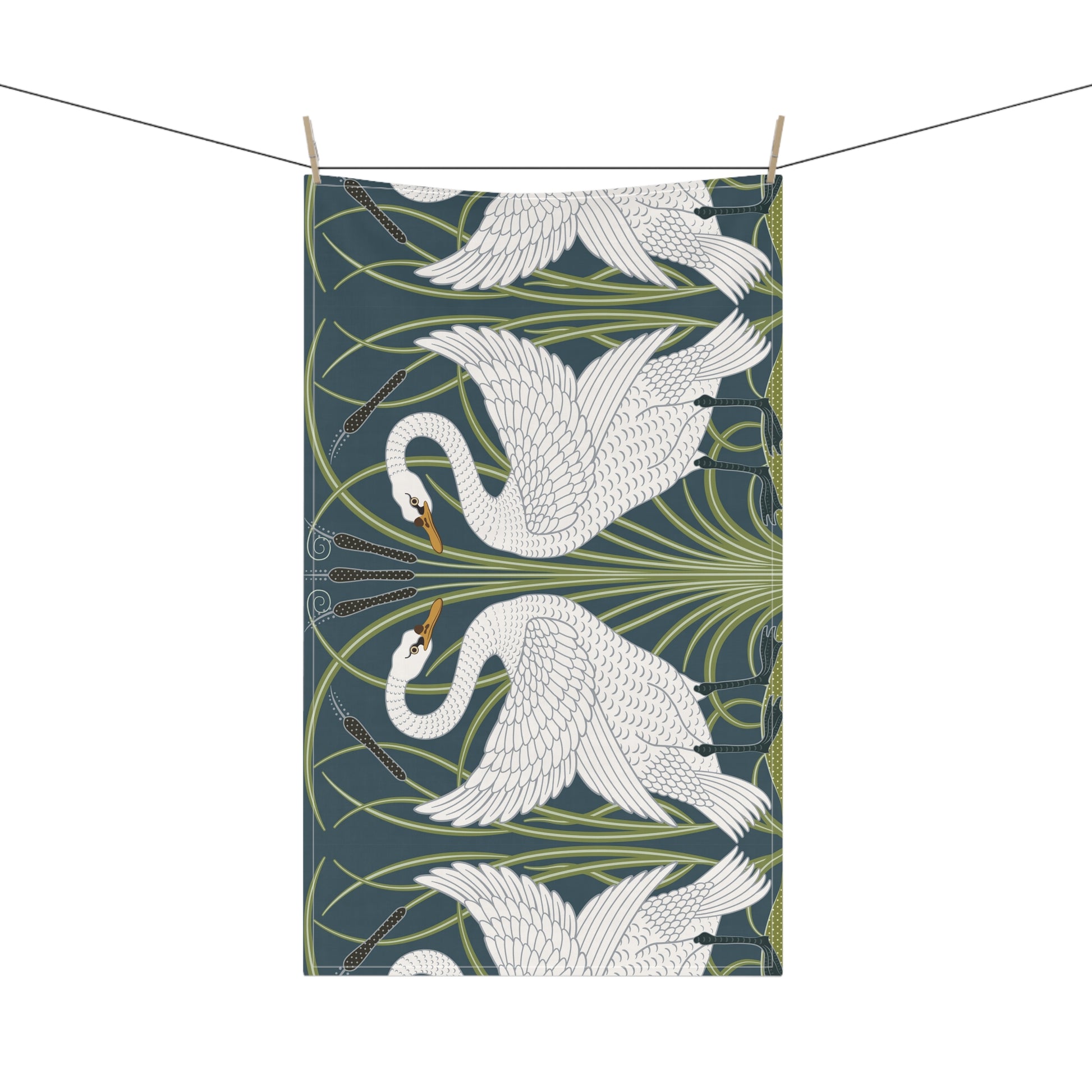 A kitchen tea towel featuring a repeated pattern of a white swan with a green and brownish background, and a set of dishes with cutlery on the side.
