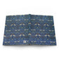 Open book with a blue floral and bird pattern on a white background
