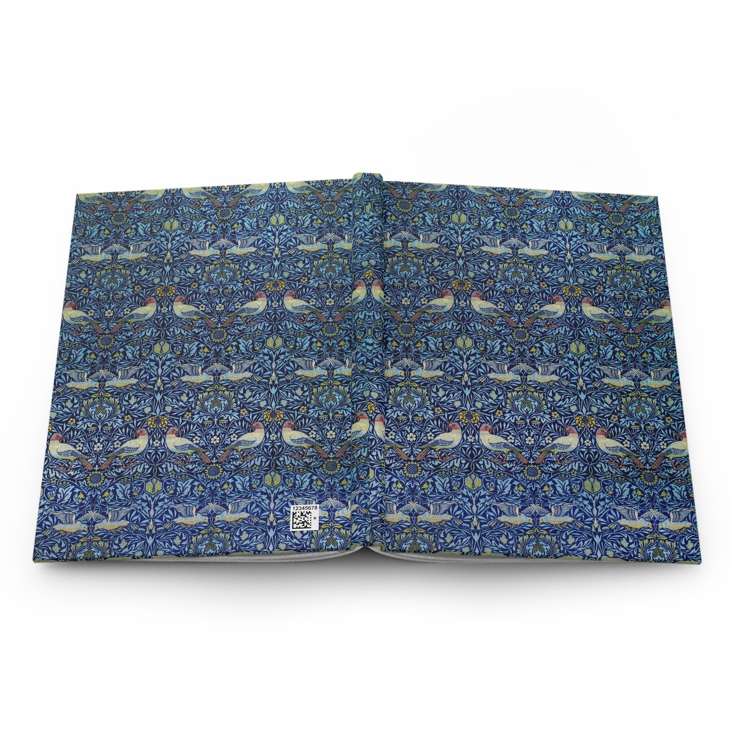 Open book with a blue floral and bird pattern on a white background