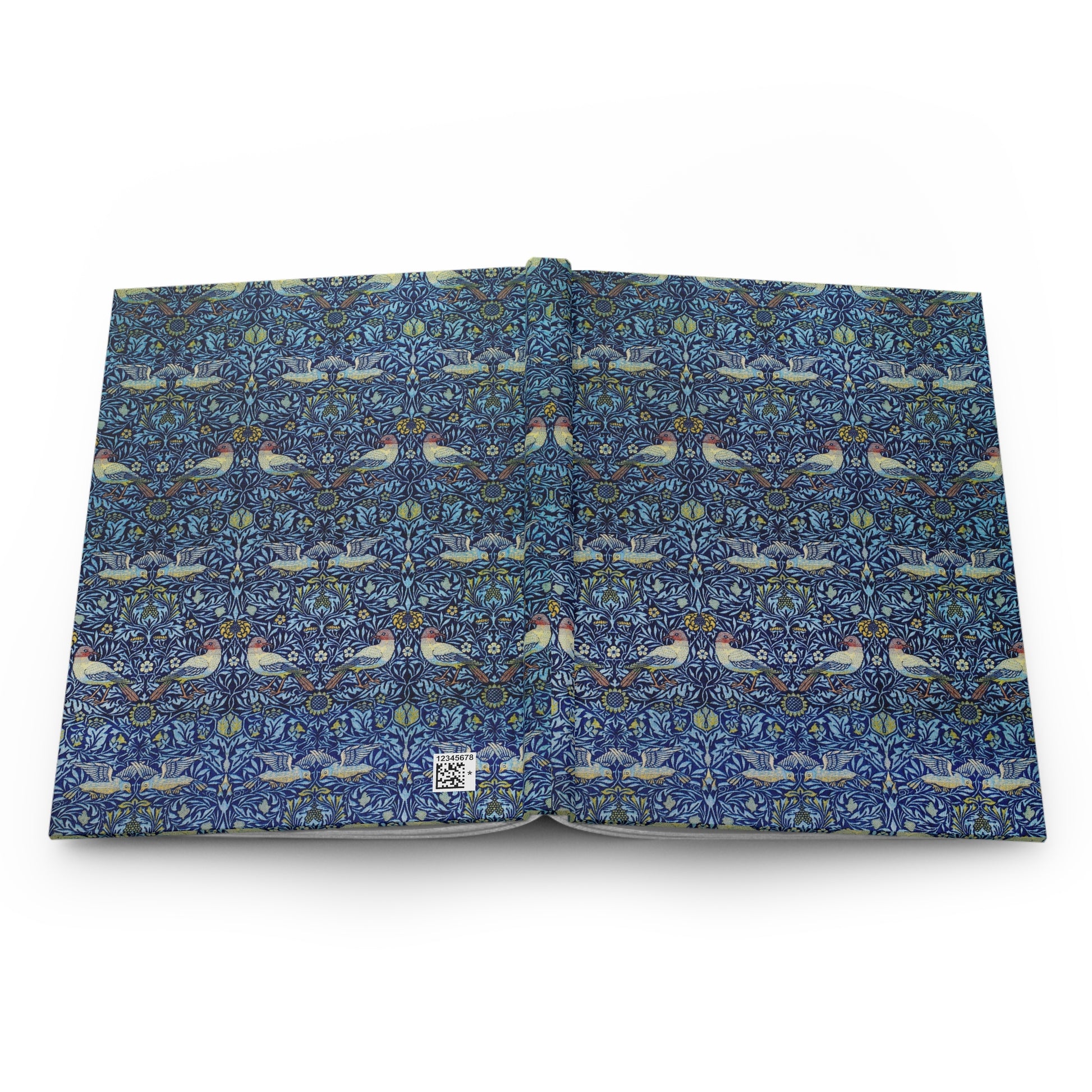 Open book with a blue floral and bird pattern on a white background