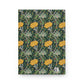 Notebook with a floral pattern featuring yellow flowers and green leaves on a dark green background.