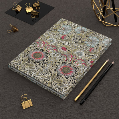 Floral William Morris & Co patterned notebook on a dark surface with office supplies