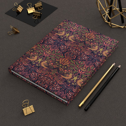 Decorative notebook with intricate patterns on a dark surface with office supplies.