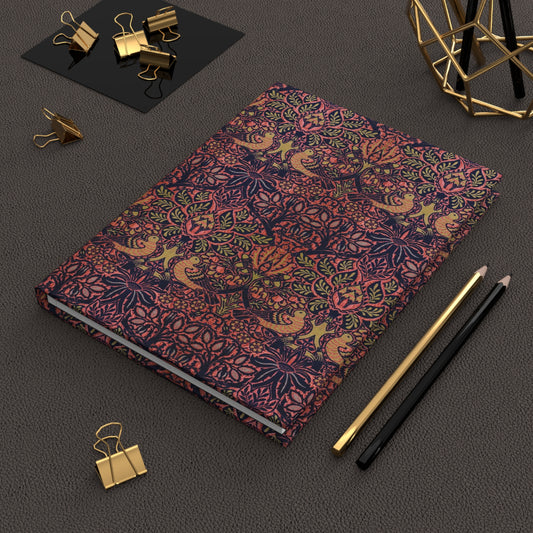 Decorative notebook with intricate patterns on a dark surface with office supplies.