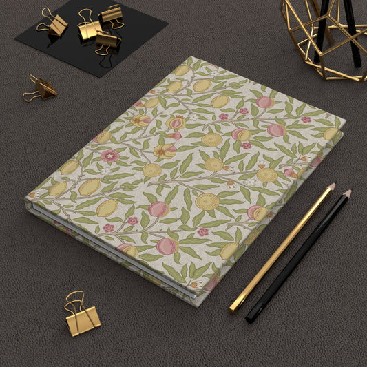 Light yellow notebook with text on a dark surface with office supplies