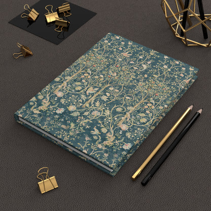 Floral patterned notebook on a dark surface with office supplies