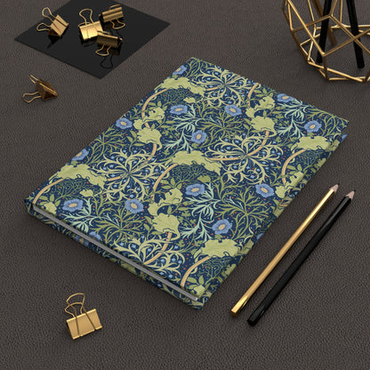 Notebook with William Morris & Co floral pattern on a dark surface with office supplies
