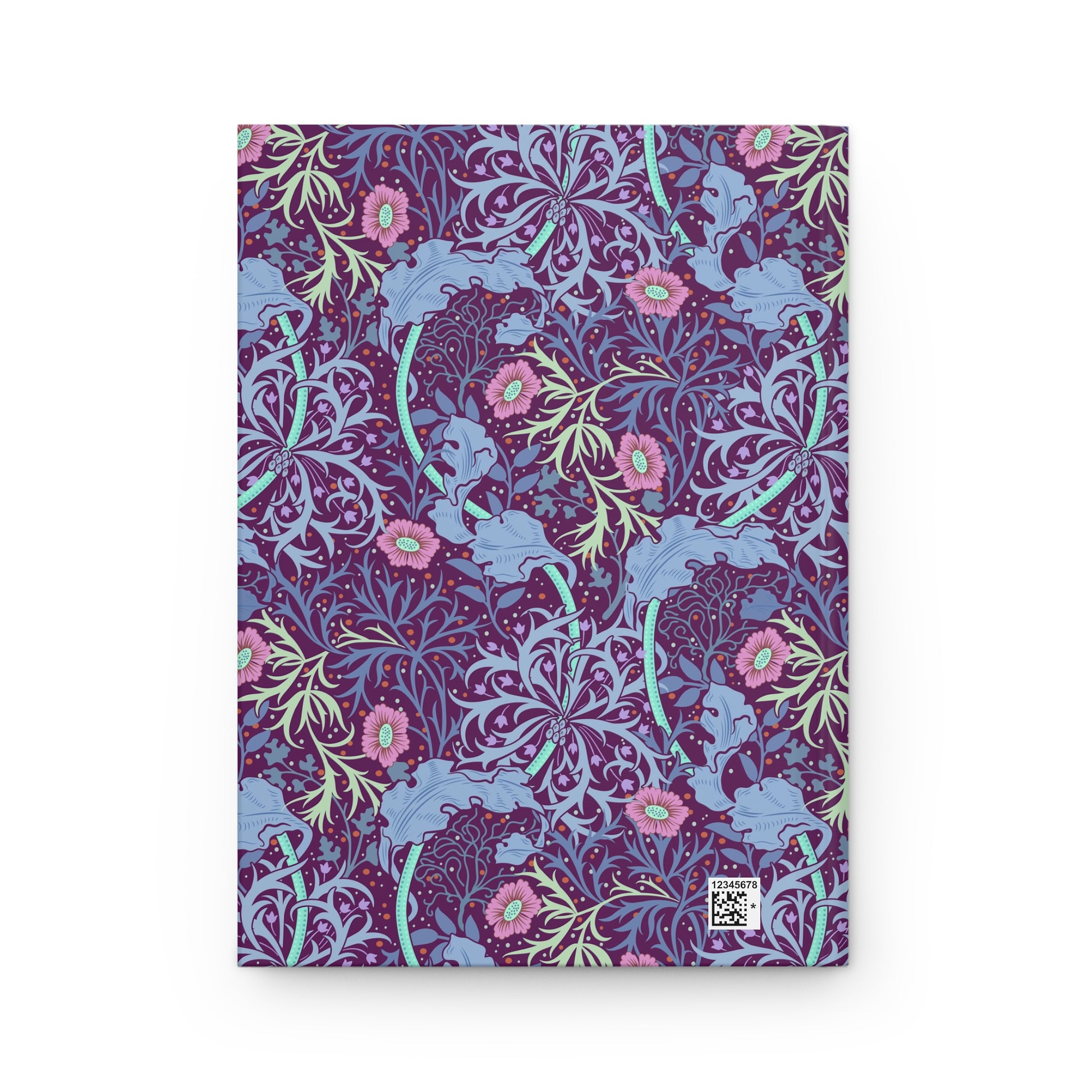 Notebook with a William Morris & Co floral and elephant pattern on a white background