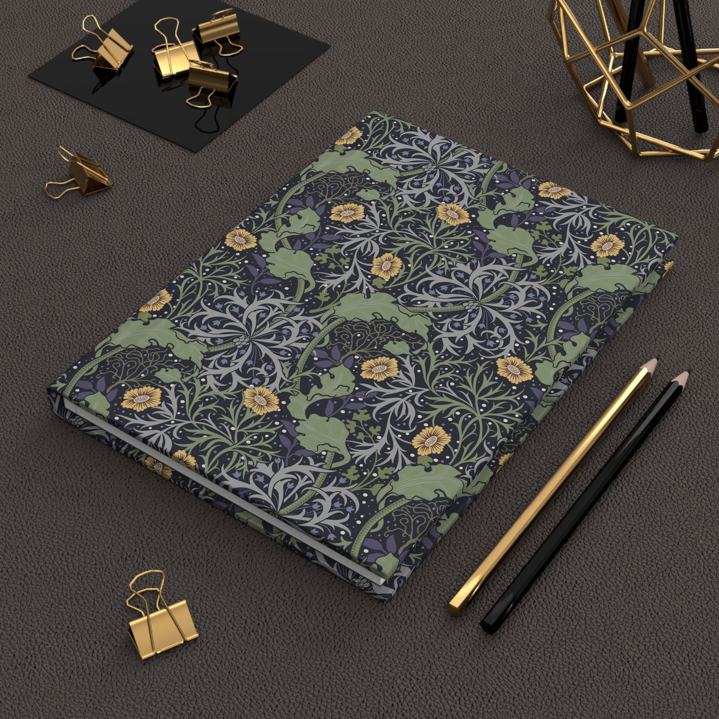 Floral William Morris & Co patterned notebook on a dark surface with office supplies