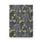Notebook with a William Morris & Co floral and dragon design on a white background