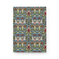 A rectangular notebook or journal with a dense, symmetrical Art Nouveau pattern featuring blue, green, red, and cream motifs, shown against a plain white background.