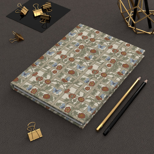 Floral-patterned William Morris & Co notebook on a dark surface with office supplies