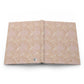 Open book with beige floral pattern on a white background