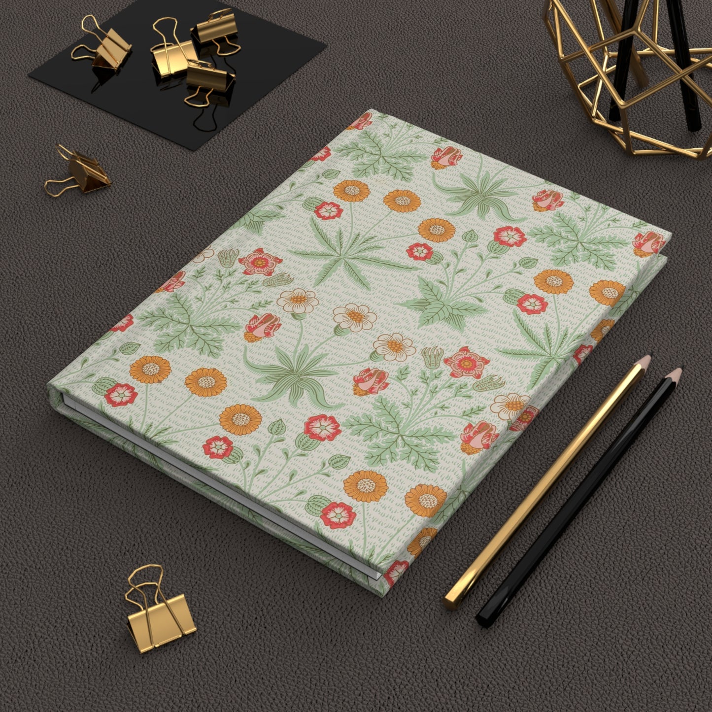 Light blue notebook with text on a dark surface with office supplies