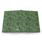 Open book with green leafy pattern on a white background