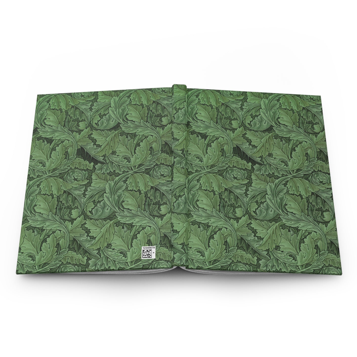 Open book with green leafy pattern on a white background