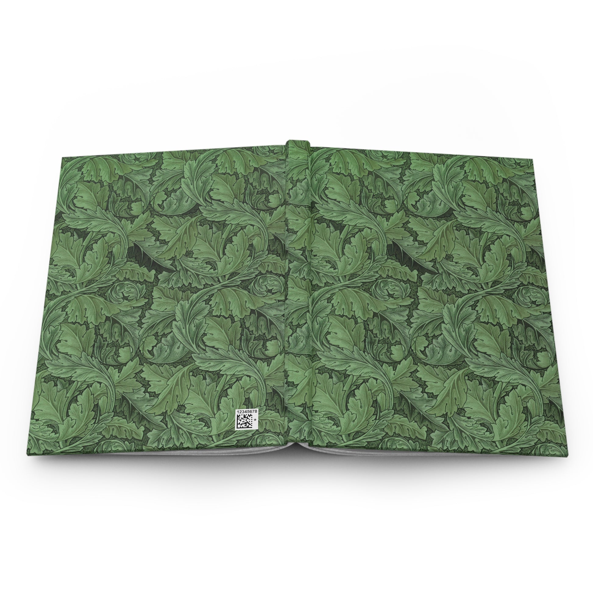 Open book with green leafy pattern on a white background