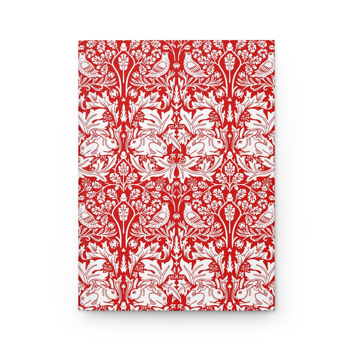 Notebook with red and white floral and bird pattern on a white background